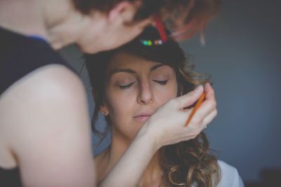 Close-up of artist applying make-up on woman