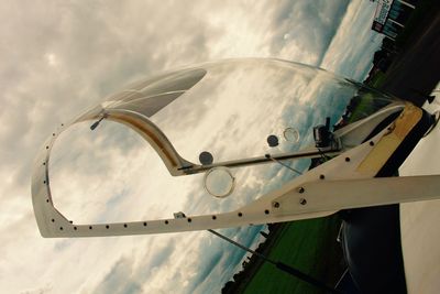 Close-up of airplane wing against sky