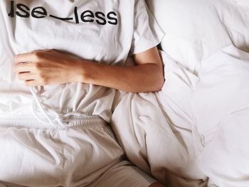High angle view of woman relaxing on bed