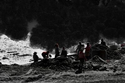 Silhouette people against sky at night