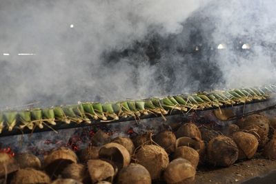 Food in wrapped leaves on barbecue grill