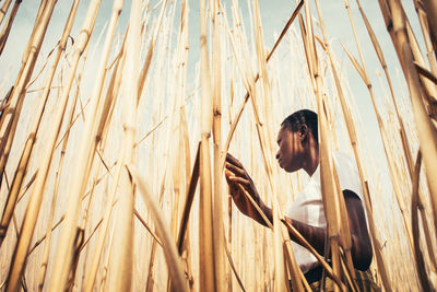 Side view of young woman standing in farm