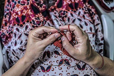 Midsection of woman knitting wool