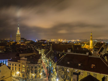 High angle view of city lit up at night