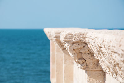 Detail of old architecture and blue sea background in italian city trani apulia