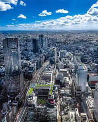 High angle view of modern buildings in city against sky