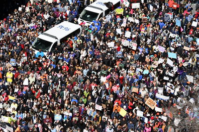 High angle view of crowd protesting on road during sunny day