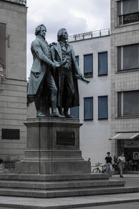 Statue against sky in city