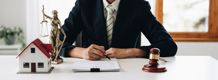 Midsection of lawyer reading book