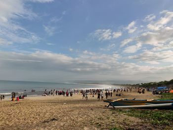 People on beach against sky