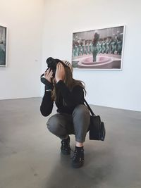 Woman sitting on mobile phone at home