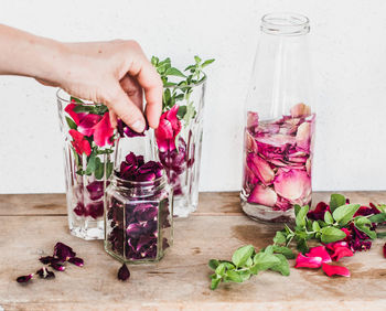 Cropped hands of person preparing food on table