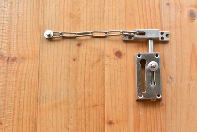 Close-up of key on wooden door