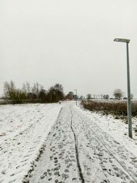 Snow covered road against sky