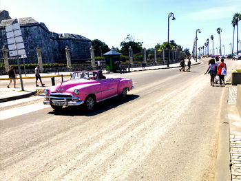 People on street in city against sky