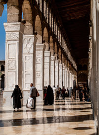 People walking in corridor of building