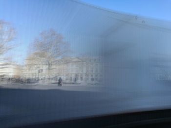 Blurred motion of person walking on glass window