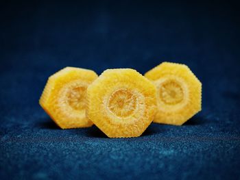 Slices of carrot against black background