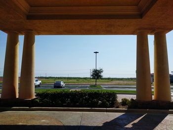 Plants by built structure against clear sky