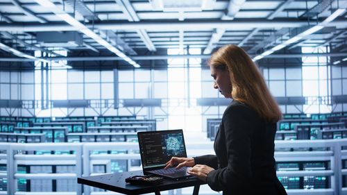 Portrait of woman using laptop on table