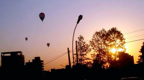 Silhouette of hot air balloon in city