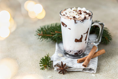 Hot chocolate or cocoa drink with marshmallow. winter holiday composition with garland.