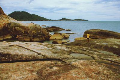 Rocks on beach against sky