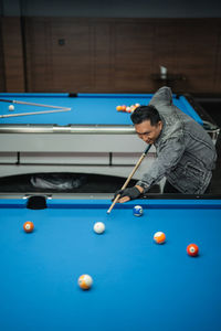 Cropped hand playing pool