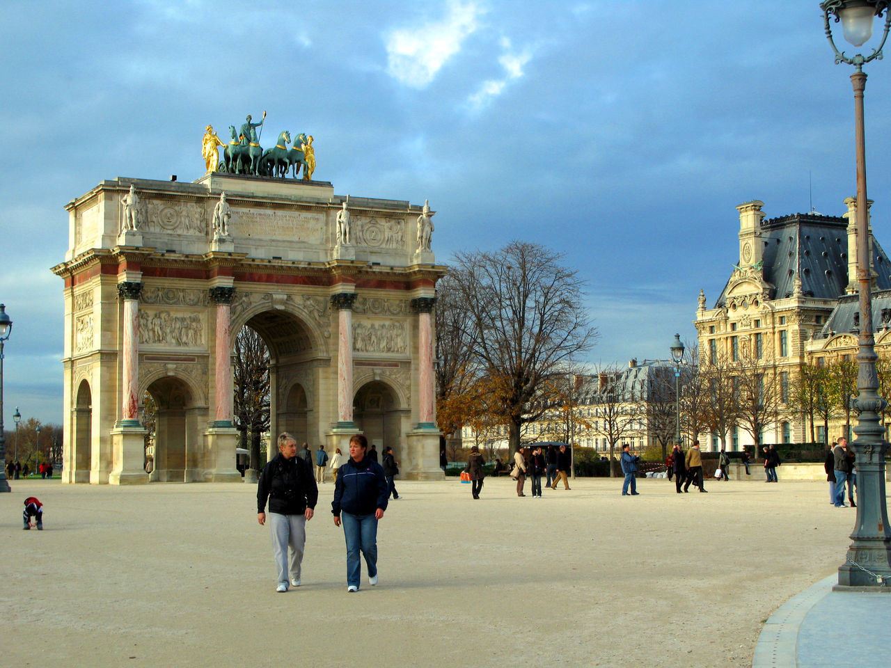 GROUP OF PEOPLE WALKING IN FRONT OF BUILDING