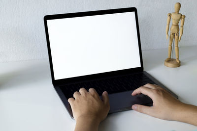 Midsection of person using mobile phone on table