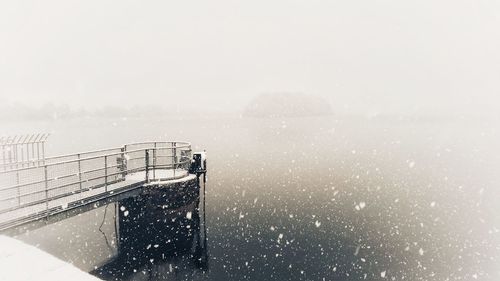 Close-up of snow on sea against clear sky