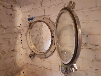 Low angle view of old electric lamp on wall