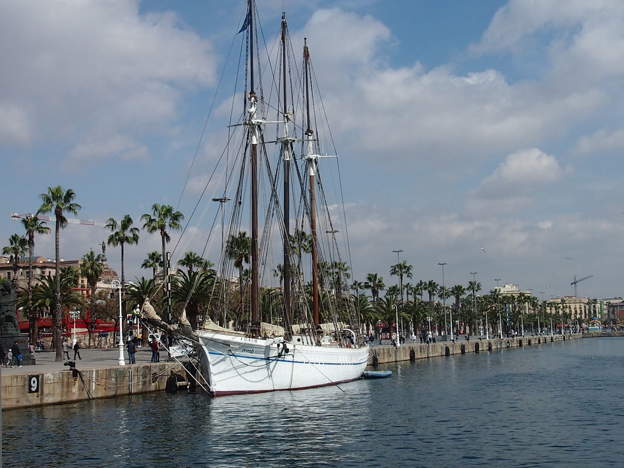 SAILBOATS MOORED AT HARBOR AGAINST SKY