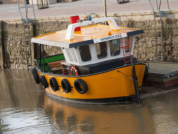Yellow moored by river