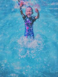 Cheerful boy playing in swimming pool