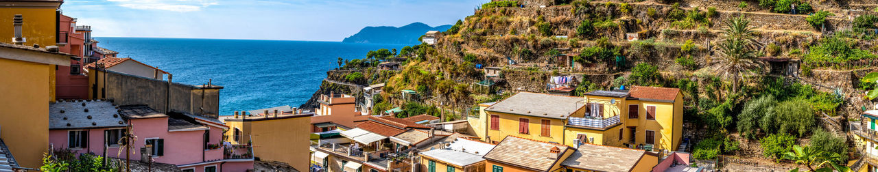 Panoramic view of buildings and sea against sky