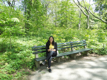 Portrait of woman sitting on bench