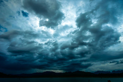 Scenic view of dramatic sky over silhouette landscape