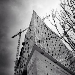Low angle view of crane against building