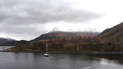 Scenic view of lake against cloudy sky