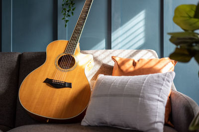 Midsection of woman playing guitar