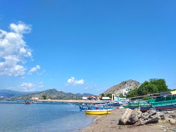 Boats moored on sea against sky