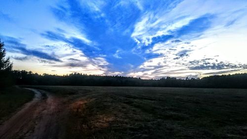 Scenic view of field against sky during sunset