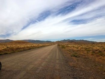 Road by landscape against sky