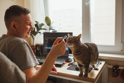 Man and woman using laptop at home