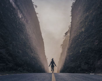 Rear view of man walking on mountain