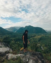 Man standing on mountain against sky