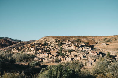 Buildings against clear blue sky