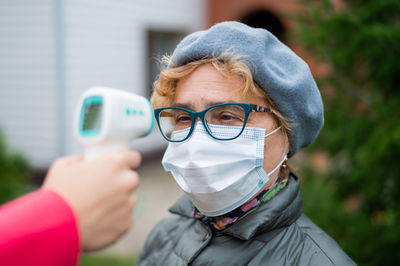 Portrait of woman holding eyeglasses