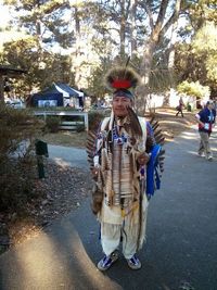 Full length of woman standing on tree trunk